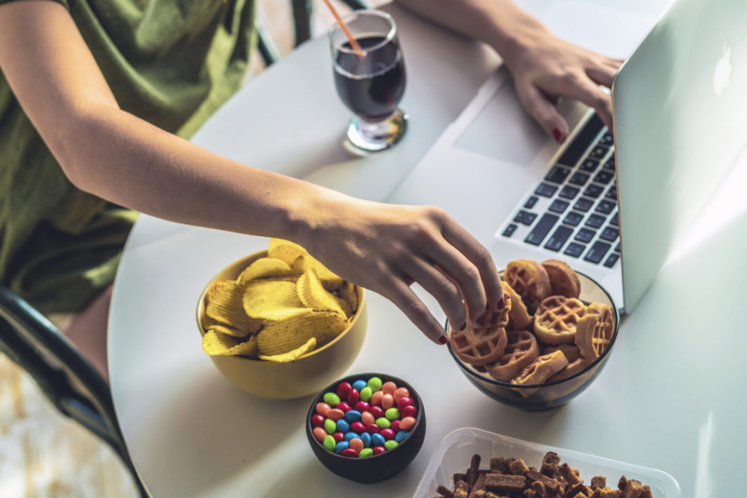 Eating snacks while using laptop