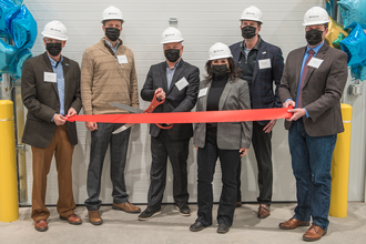Scoular executiveds celebrate ribbon cutting at the company's new barley protein plant in Jerome, Idaho