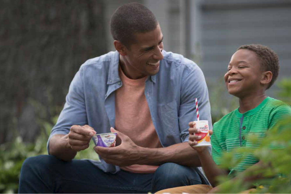 Father and son eating Yoplait yogurt