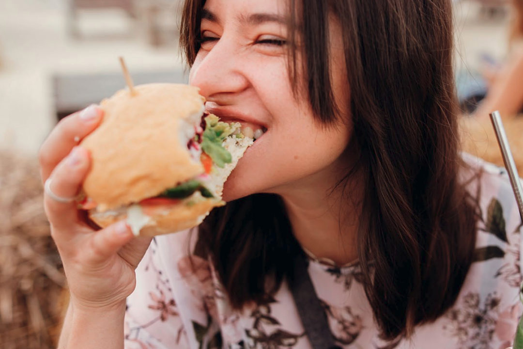 Woman eating sandwich