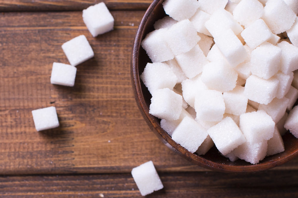 Sugar cubes in wooden bowl