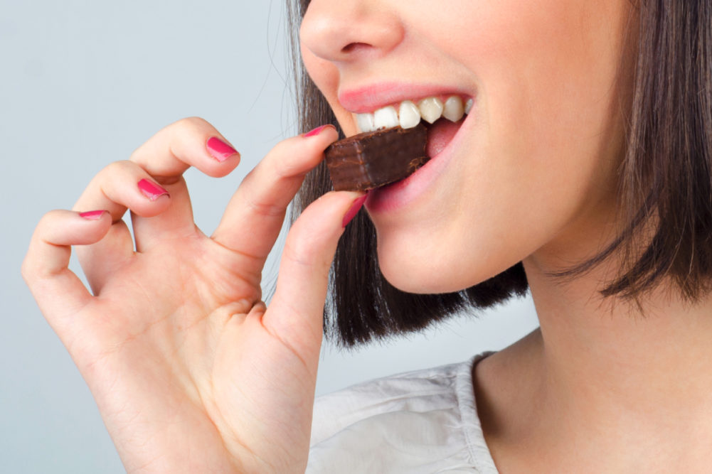 Woman eating chocolate cookie