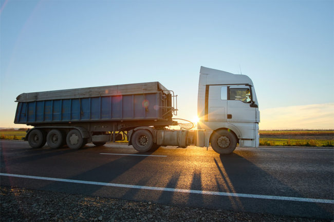 Truck on highway, sunset