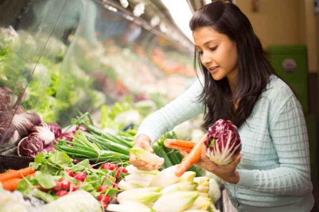 Consumer selecting produce