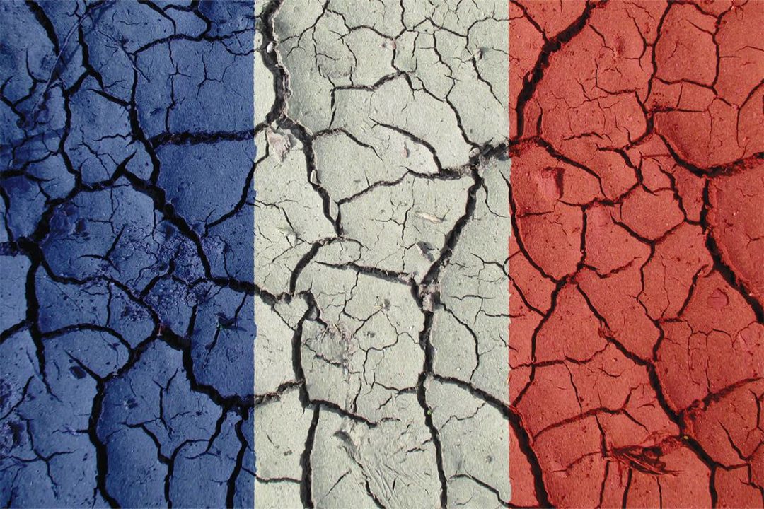 French flag over dry soil