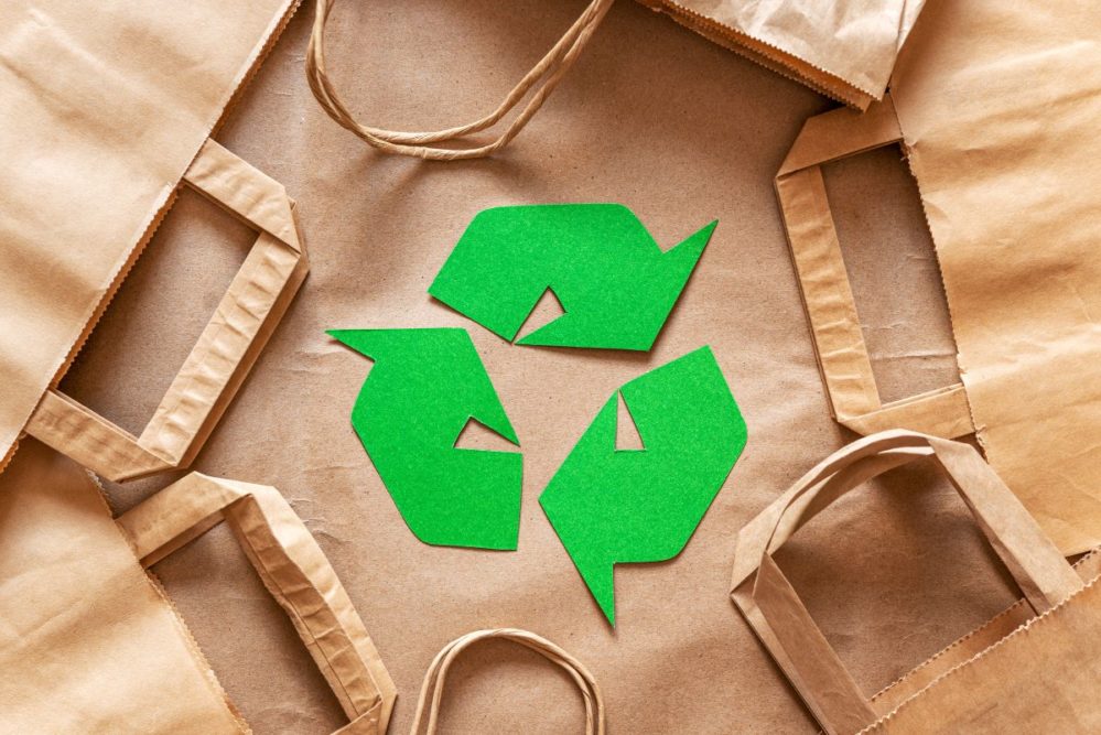 Green recycling symbol, brown paper bags, Adobe Stock