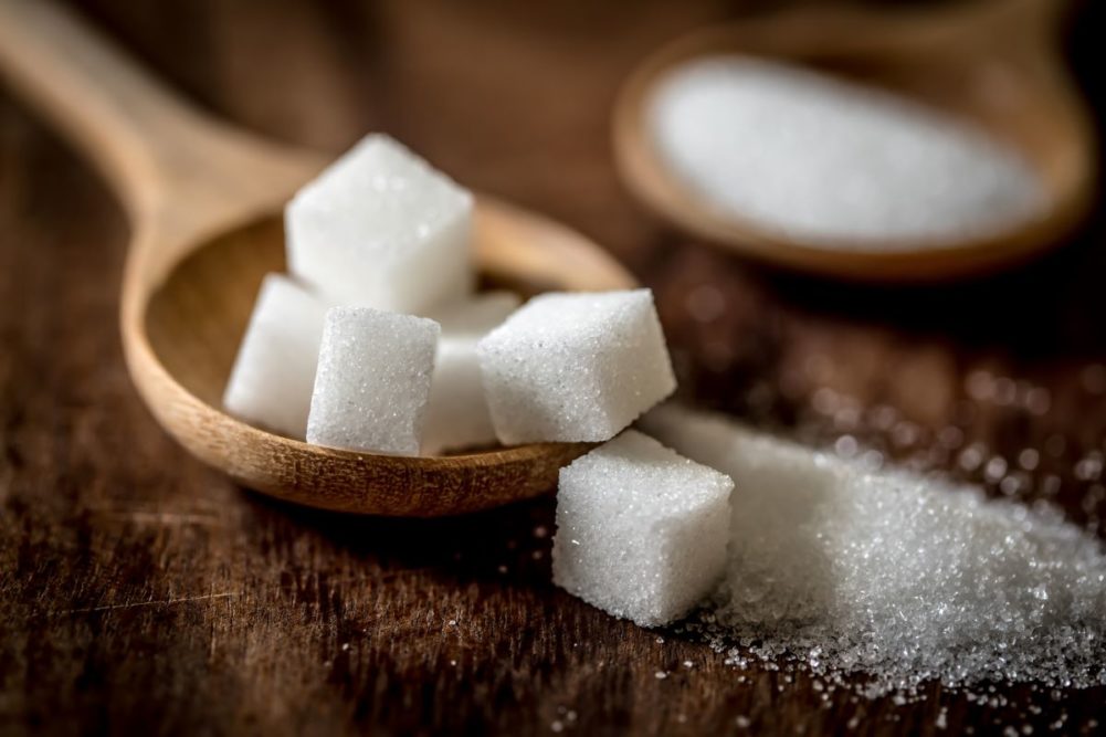 Sugar cubes on a wooden spoon