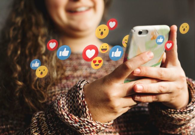Tween using smart phone, emoji reactions