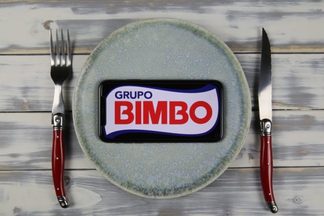 Grupo Bimbo website on a smartphone, place setting, fork and knife