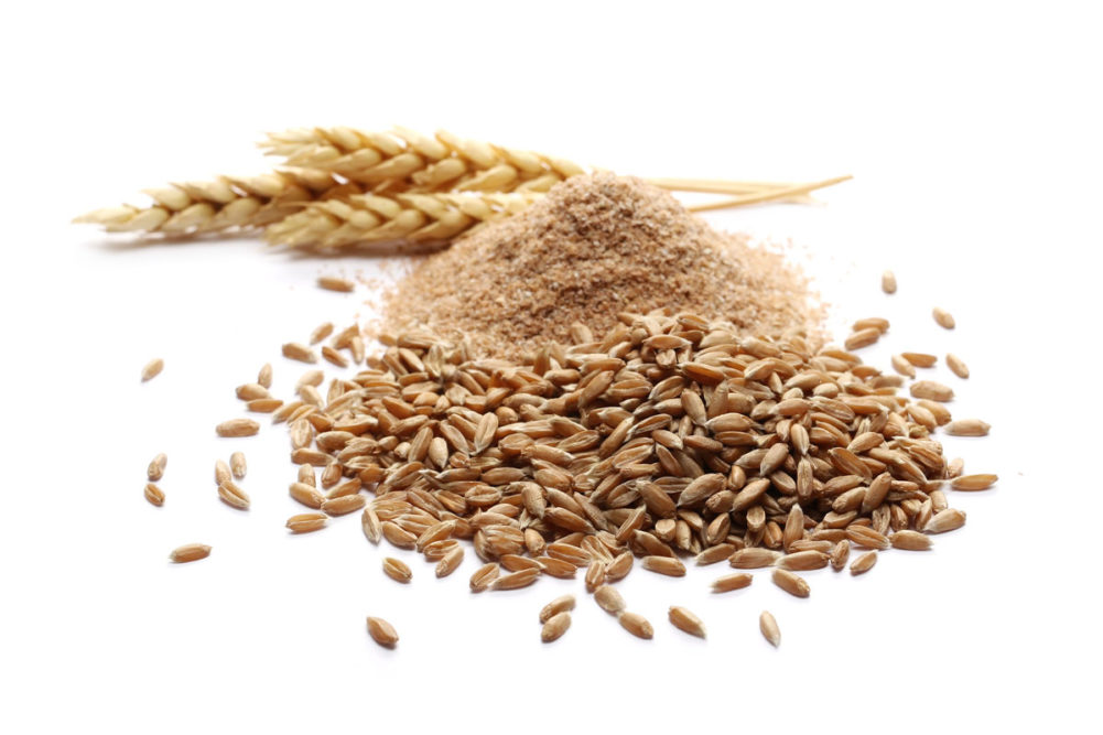 Spelt bran and grains with ears of wheat