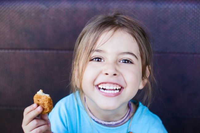Child eating a chicken nugget