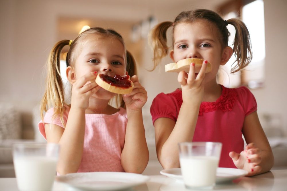 Children eating jam and toast