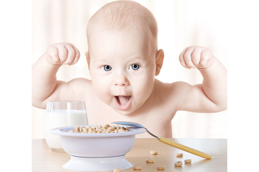 Strong baby eating cereal