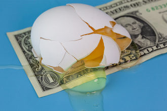 Broken egg on dollar bill