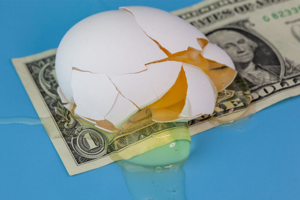 Broken egg on dollar bill