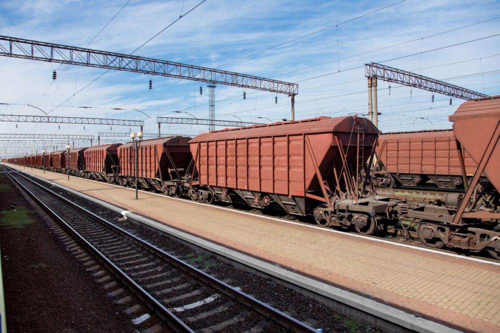 Train carrying grain, rail yard