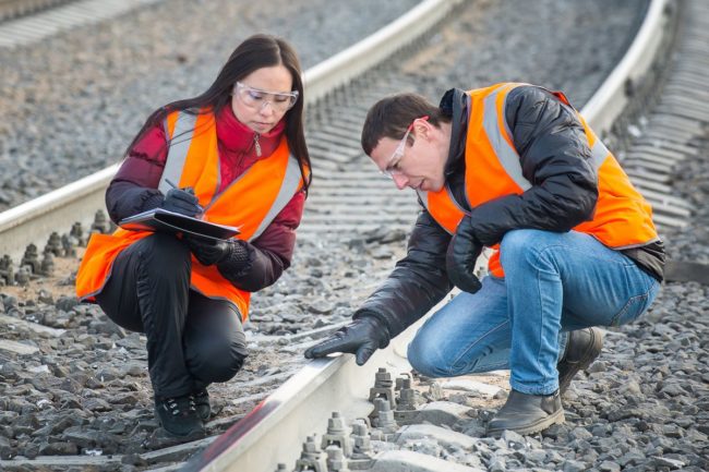 Rail workers inspecting a track