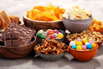 Bowls of candy and snacks, chips, chocolate, candy, popcorn