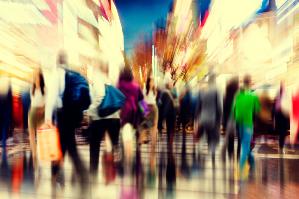 Graphic of crowded sidewalk in motion, blurry