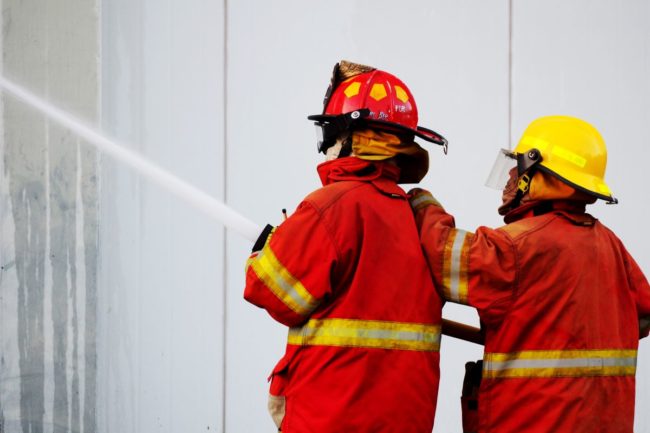 Firefighters hosing down a building