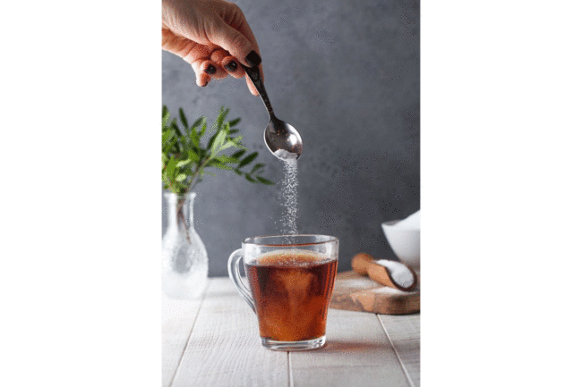 Sweetener pouring into tea