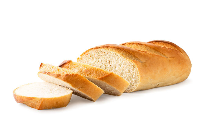 A loaf of white bread cut into thin slices. 