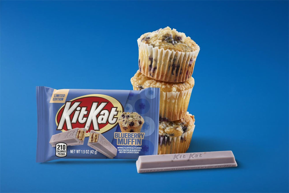 Blueberry Muffin flavored Kit Kats over blue background. 