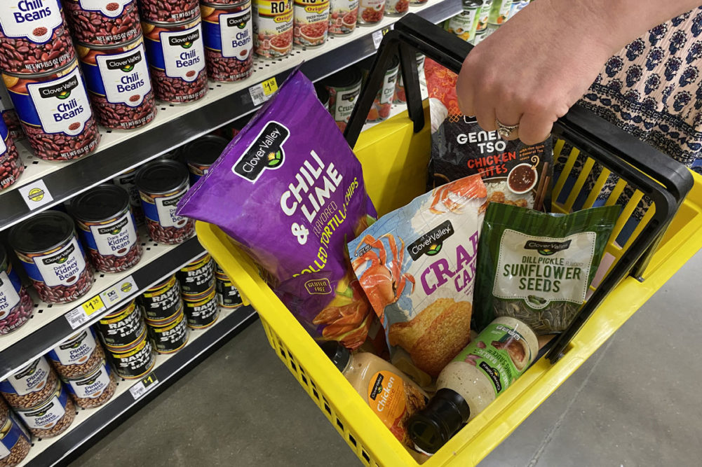 Assortment of Dollar General products in yellow grocery basket. 