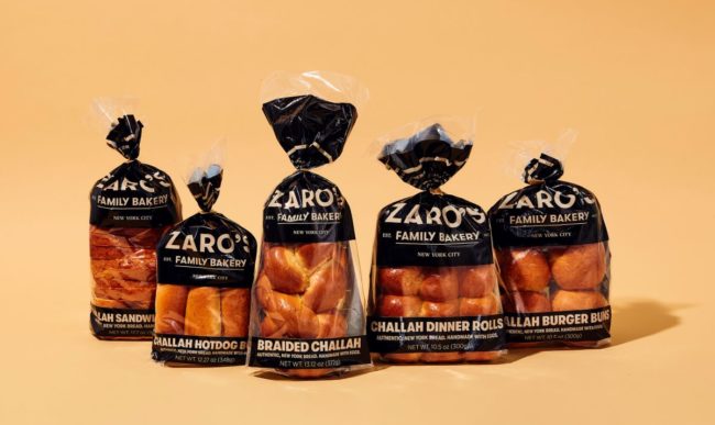 Assortment of new Zaro's Challah bread products against a honey mustard colored background. 