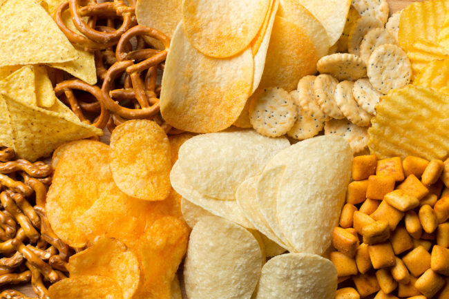 Assortment of snacks including pretzels and potato chips. 