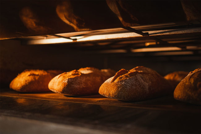 Loaves of bread baking in electric oven. 