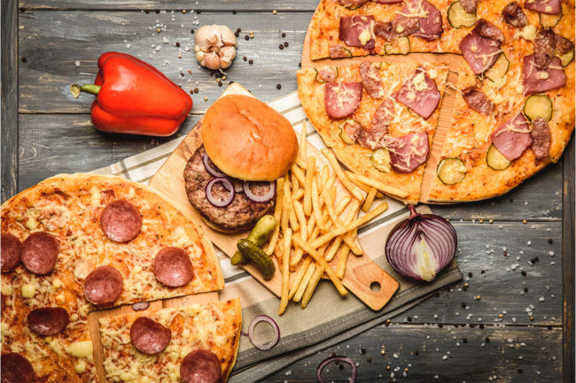 Two whole pizzas, a burger and a side of fries. 