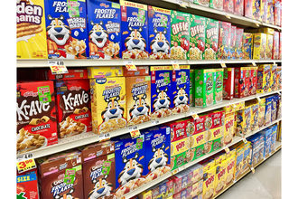 Assortment of Kellogg cereals in grocery aisle. 