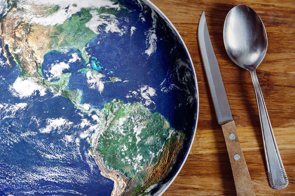 A globe next to a set of utensils. 