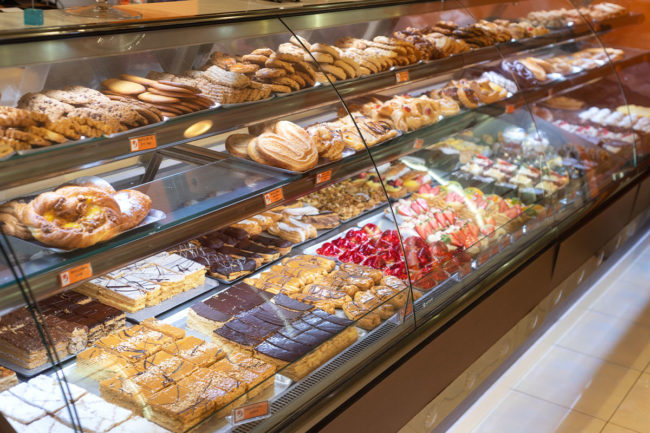 Assortment of cookies and cakes in bakery window. 