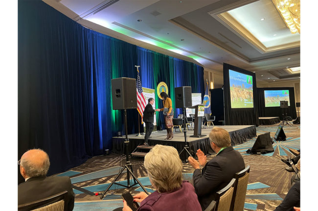Deputy Secretary of Agriculture Xochitl Torres Small welcomes US Department of Agriculture chief economist Seth Meyer to the stage after welcoming attendees to the 100th annual USDA Agricultural Outlook Forum.