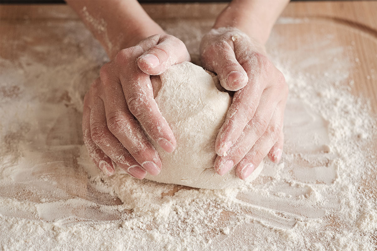Hands making bread from scratch. 