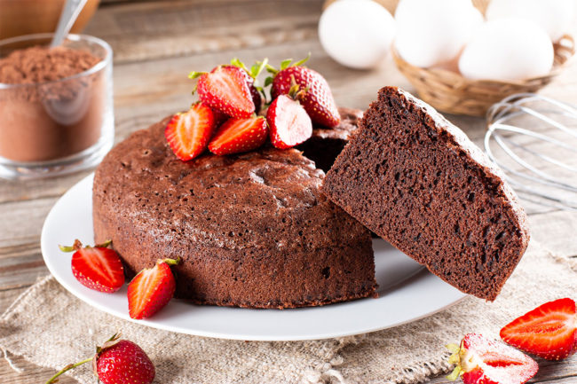 Cocoa free chocolate cake topped with strawberries. 