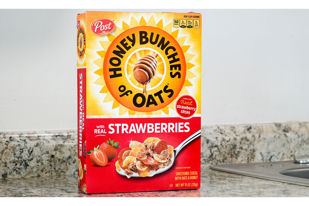 Box of Honey Bunches of Oats with Strawberries on kitchen counter. 