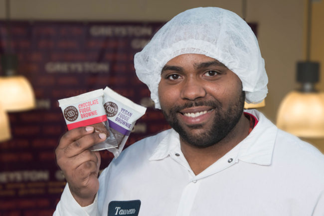 Greyston Bakery worker holding brownies